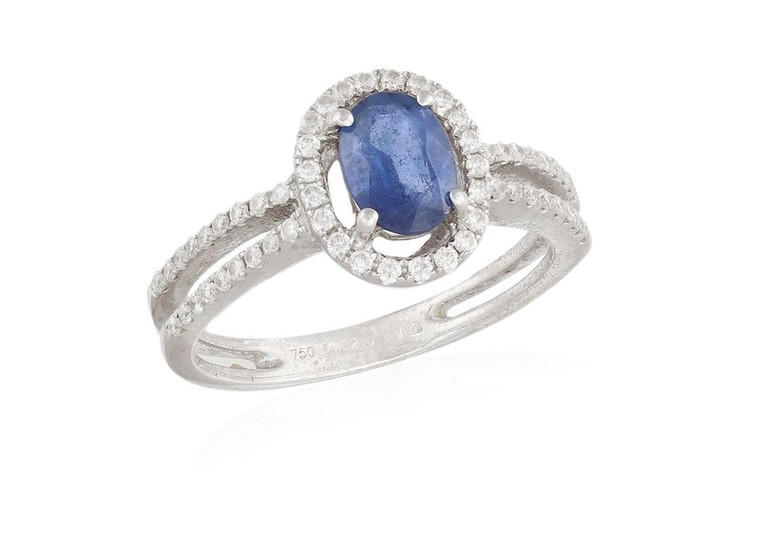 A SAPPHIRE AND DIAMOND RING, the oval-shaped sapphire...