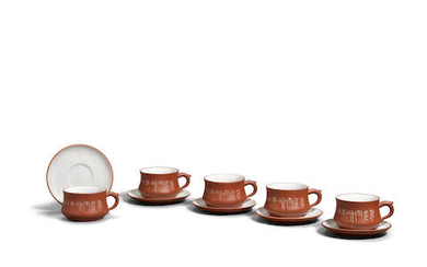 A SET OF FIVE YIXING STONEWARE CUPS AND SAUCERS