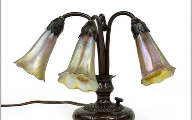A Tiffany Studios Three-Light Lily Piano Lamp.