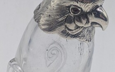 A Victorian silver bird pepper, glass body, red eyes,...