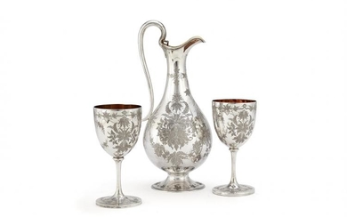 A Victorian silver claret jug and a pair of goblets by George Adams for Chawner & Co.