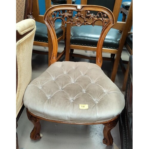 A Victorian walnut nursing chair with buttoned down overstuf...
