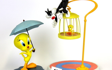 A Wedgwood limited edition porcelain figure of Tweety and Sylvester and a further Coalport figure of Tweety under an umbrella.