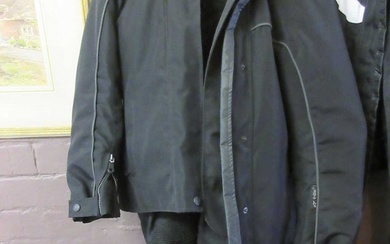 A black canvas motorcycle jacket with matching trousers by Alpine...