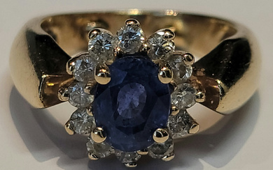 A blue sapphire and diamond ring in 14k yellow gold