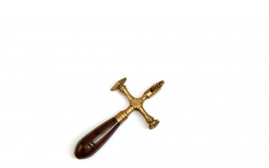 A brass pastry jigger with double print and wooden handle (cfr. Landini pg. 67)