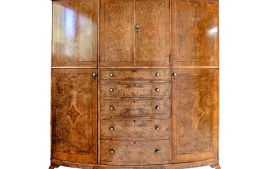 A burr walnut and crossbanded bow front wardrobe.