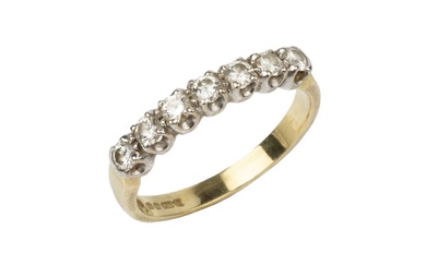 A diamond dress ring, set with a line of seven...