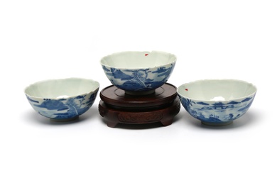A group of blue and white small bowls painted with landscape design