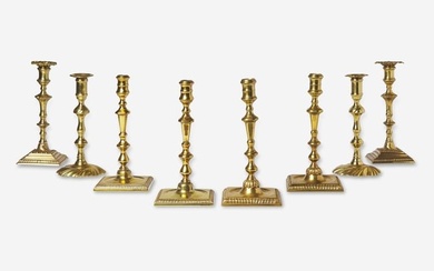 A group of eight Chippendale brass candlesticks, England, late 18th century