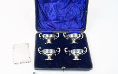 A group of silver, comprising: a cased set of four twin handled urn shaped salts, Birmingham, 1913, William Hutton & Sons Ltd, lacking spoons, 9cm wide; together four associated silver salt spoons; a card case, Birmingham, 1905, Thomas Hayes, of...
