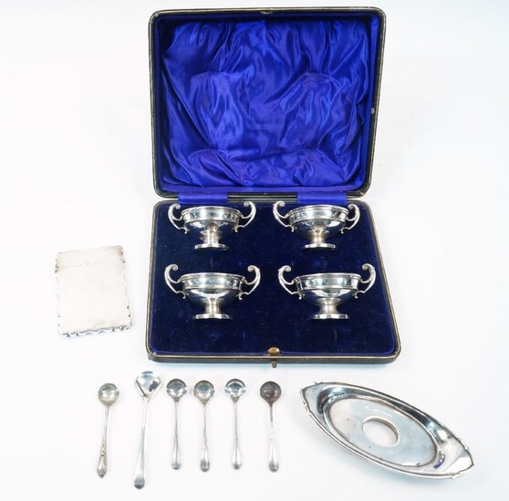 A group of silver, comprising: a cased set of four twin handled urn shaped salts, Birmingham, 1913, William Hutton & Sons Ltd, lacking spoons, 9cm wide; together four associated silver salt spoons; a card case, Birmingham, 1905, Thomas Hayes, of...