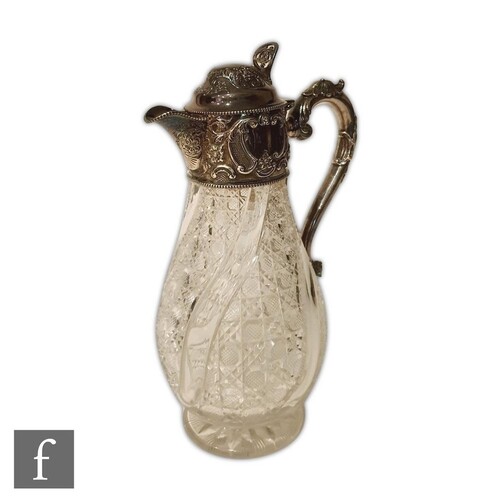 A hallmarked silver and clear glass claret jug, the baluster...