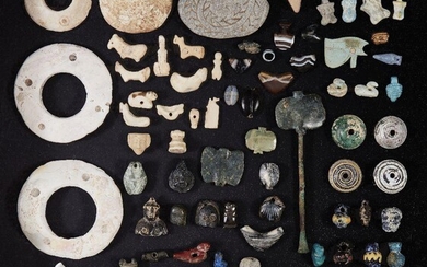 A large group of Near Eastern and Eastern Mediterranean beads and amulets Late 5th Millennium B.C. - 1st Millennium A.D. and Later Including four Western Asiatic mainly shell disc rings with circle designs, once inlaid, 7.4cm max diam, one damaged;...