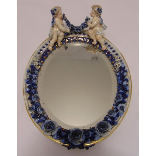 A late 19th century continental porcelain wall mirror, oval ...