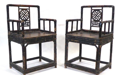 A pair of Chinese bamboo and lacquered elbow chairs with...