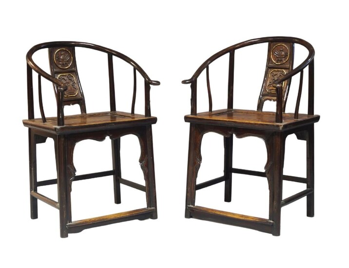 A pair of Chinese horseshoe back chairs, quanyi, early 20th century, with carved back panel decorated with a vase of flowers and a vase of fruit, 95cm high (2)