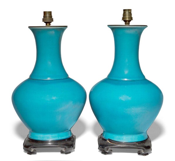 A pair of Chinese porcelain monochrome blue-glazed vases, early 20th century, covered in an allover blue glaze, converted to lamps with wood bases, 40.5cm high (2) Provenance: From the collection of an important Greek shipping family