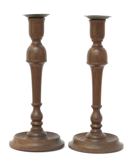A pair of Cotswold School walnut candlesticks