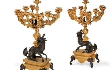 A pair of French Japonisme bronze candelabra