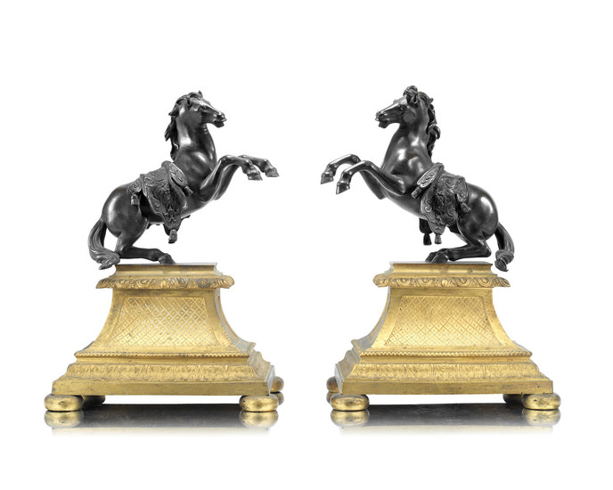 A pair of French patinated bronze models of rearing horses in the manner of models by Francesco Fanelli (Italian, 1577-after 1641) raised on gilt bronze bases