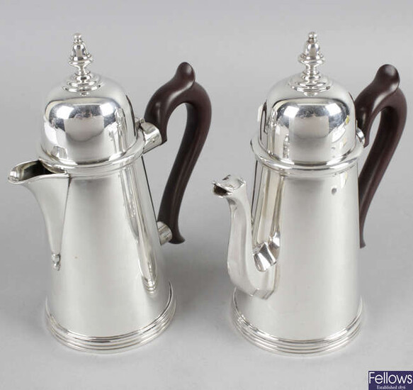 A pair of Queen Anne style silver coffee pot and hot water jugs.