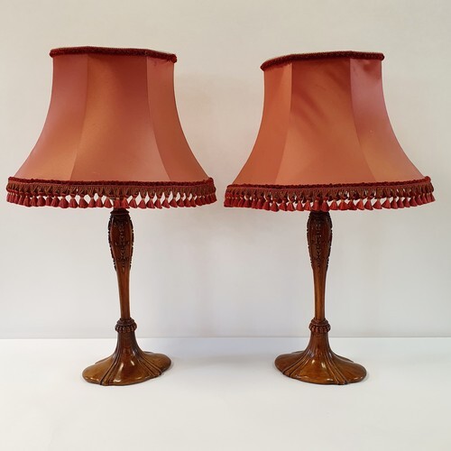 A pair of carved walnut lamp bases, 47 cm high