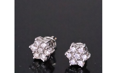 A pair of diamond daisy cluster earrings set in 18ct gold