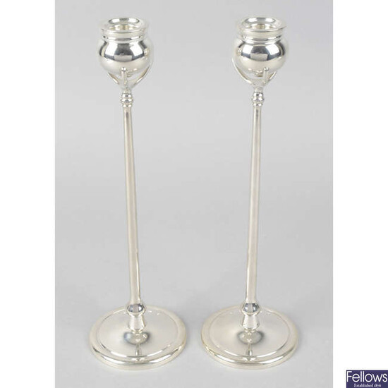 A pair of modern silver reproduction candlesticks.