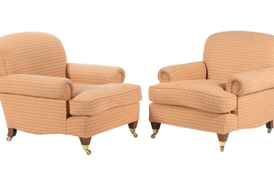 A pair of upholstered armchairs in the manner of George Smith