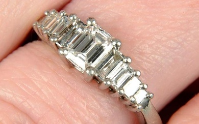 A platinum graduated baguette-cut diamond dress ring.Principal diamond laser inscribed GIA