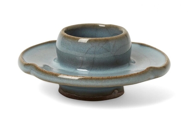 A rare Chinese Junyao quatrilobe cup stand, Song dynasty, the holder moulded with convex sides supported on a quadrilobed saucer with a slightly upturned rim, covered in a thick pale lavender-blue glaze thinning to a buff tone at the rims and...