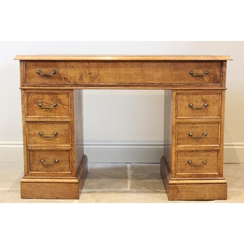A reproduction honey oak twin pedestal desk, late 20th centu...