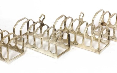 A set of four silver toast racks