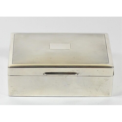 A silver cigarette box, Birmingham 1945, with engine turned ...