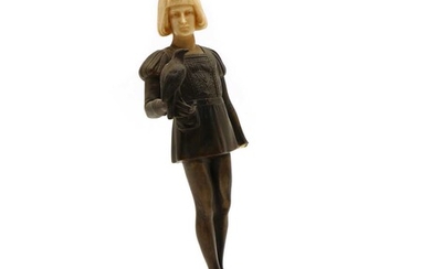 A spelter figure of a boy holding a hawk