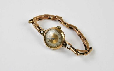 A vintage lady's 9ct yellow gold wristwatch with Arabic numerals...