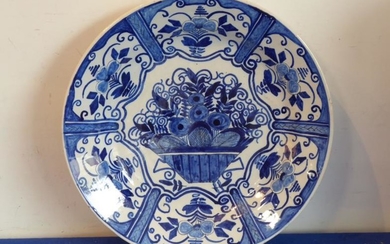 An 18th century Delftware charger hand-decorated in cobalt-blue with...