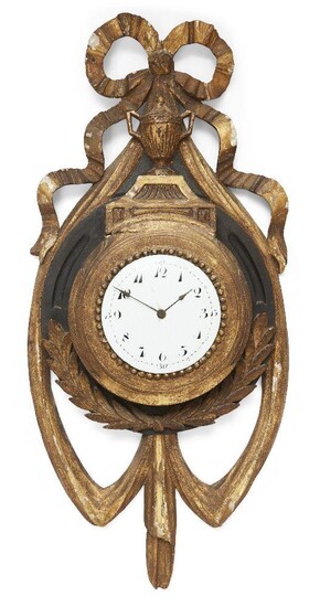 An Austrian gilt-wood and ebonised wall timepiece, circa 1900, the case surmounted with a ribbon-tied bow above a fluted twin-handled urn, the white enamel dial with Arabic numerals, having cylinder movement, 70cm high Please note that Roseberys do...