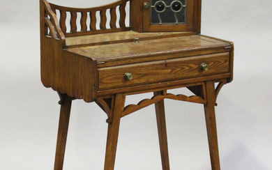 An Edwardian Arts and Crafts stained ash writing table, in the manner of Liberty & Co, the galle