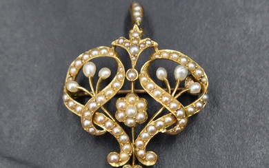 An Edwardian yellow metal brooch/pendant stamped 15ct having extensive seed pearl decoration, approx