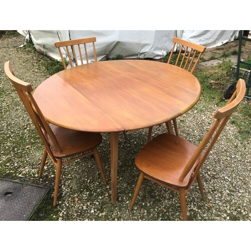 An Ercol oval drop leaf table with blue label. 113cm x 125cm...