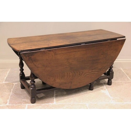 * An early 18th century oak gateleg dining table, the oval t...