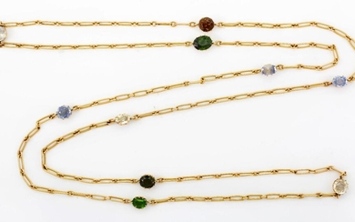 An early 20th century gold multi- gem-set guard chain, of fetter-link design with claw-set gem intervals, gems include sapphire, green tourmaline, zircon, quartz and one green paste, c. 1910, length 100cm