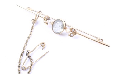 An early 20th century gold, pale aquamarine and seed-pearl three stone bar brooch.