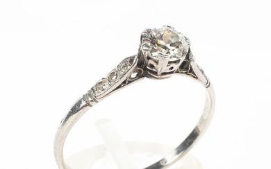 An early 20th century platinum and diamond dress ring with central 4mm diamond in a six-claw
