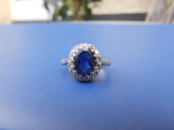 An oval sapphire & diamond cluster ring on '18ct'...