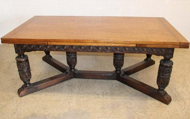 Antique solid oak Jacobean style dining room table with 2 self storing 21" extensions