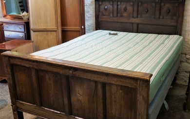 Charles II Style Oak Bed, Decorated with roundels, Raised on metal castors, With side rails, Later