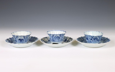 China, a set of three blue and white porcelain 'fisherman' cups and saucers, 18th century